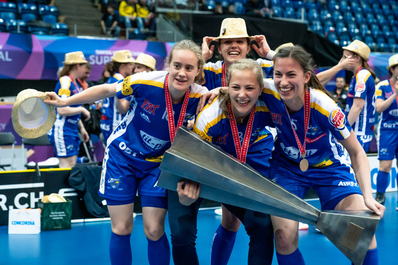 SWISS Arena (Kloten), 27.04.2019, Unihockey Damen NLA Superfinal, piranha chur - Kloten-Dietlikon Jets, Kassandra Luck (Nr. 18, Kloten-Dietlikon Jets), Natalie Schürpf, Andrea Gämperli (Nr. 5, Kloten-Dietlikon Jets) und Linda Pedrazzoli (Nr. 13, Kloten-Dietlikon Jets) mit dem Pokal
(Claudio Schwarz, unihockey-fotos.ch)
Copyright: Claudio Schwarz, unihockey-fotos.ch – Dieses Bild wurde durch swiss unihockey lizenziert und darf ausschliesslich auf den Online-Kanälen von swiss unihockey verwendet werden. Die redaktionelle oder kommerzielle Nutzung durch Dritte (Medien, Vereine, Unternehmen oder Privatpersonen) per Download von diesem flickr-Account ist ausgeschlossen. Das Bild kann bei Interesse via unihockey-fotos.ch kostenpflichtig lizenziert werden. unihockey-fotos.ch behält sich vor, fehlbaren Medien, Vereinen, Unternehmen oder Privatpersonen Bilder mit einem Zuschlag in Rechnung zu stellen.